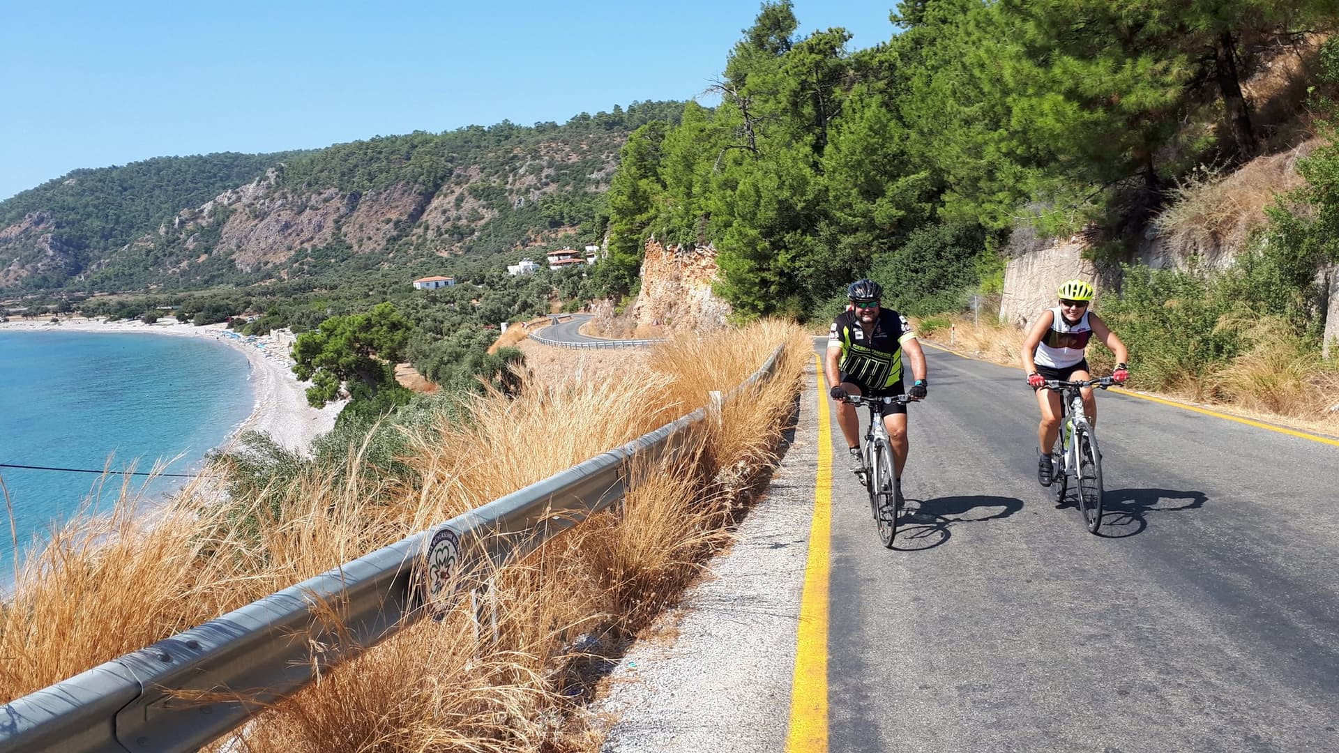 Two cyclists riding along a scenic coastal road on Turkey’s Aegean Coast