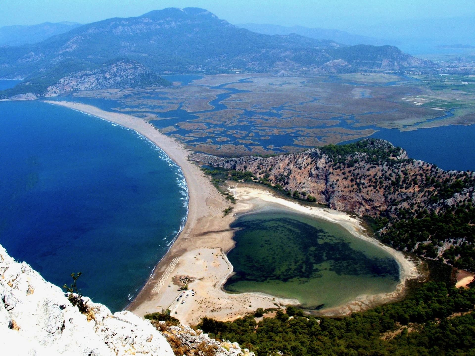 Aerial view of a turquoise lagoon and sandy beach on the Aegean coast