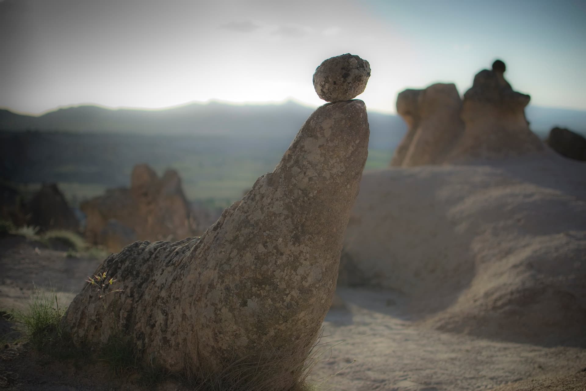 Balanced fairy chimney rock formation silhouetted at sunset in Cappadocia