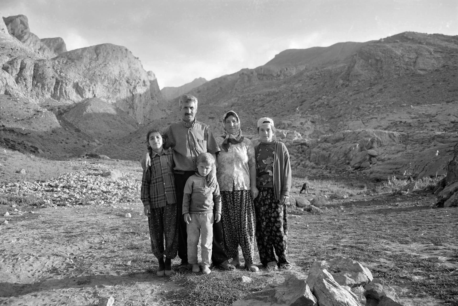 Black-and-white family portrait standing before rocky peaks in the Taurus Mountains
