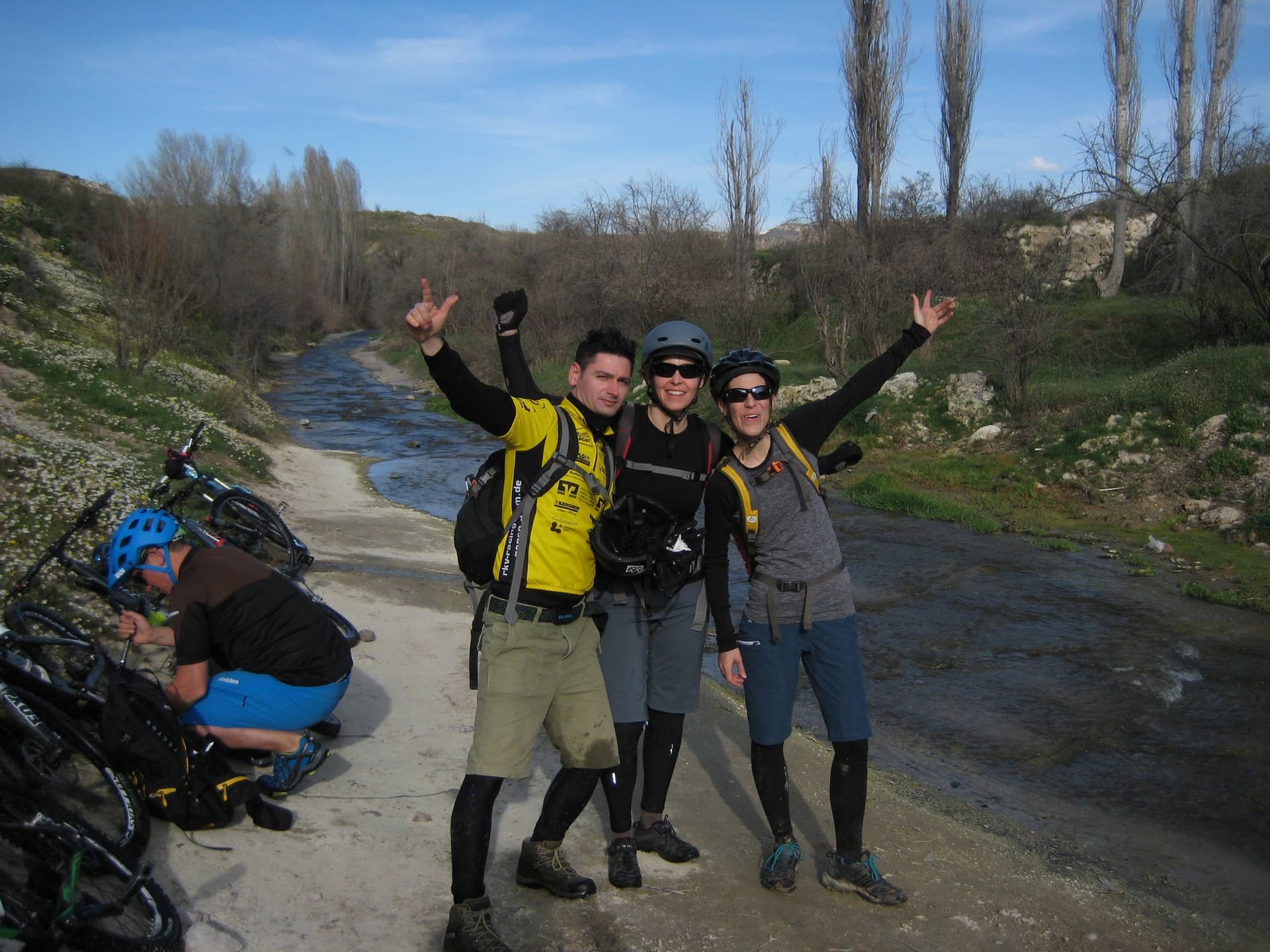 Cyclists posing beside a stream-lined path in Cappadocia after a ride