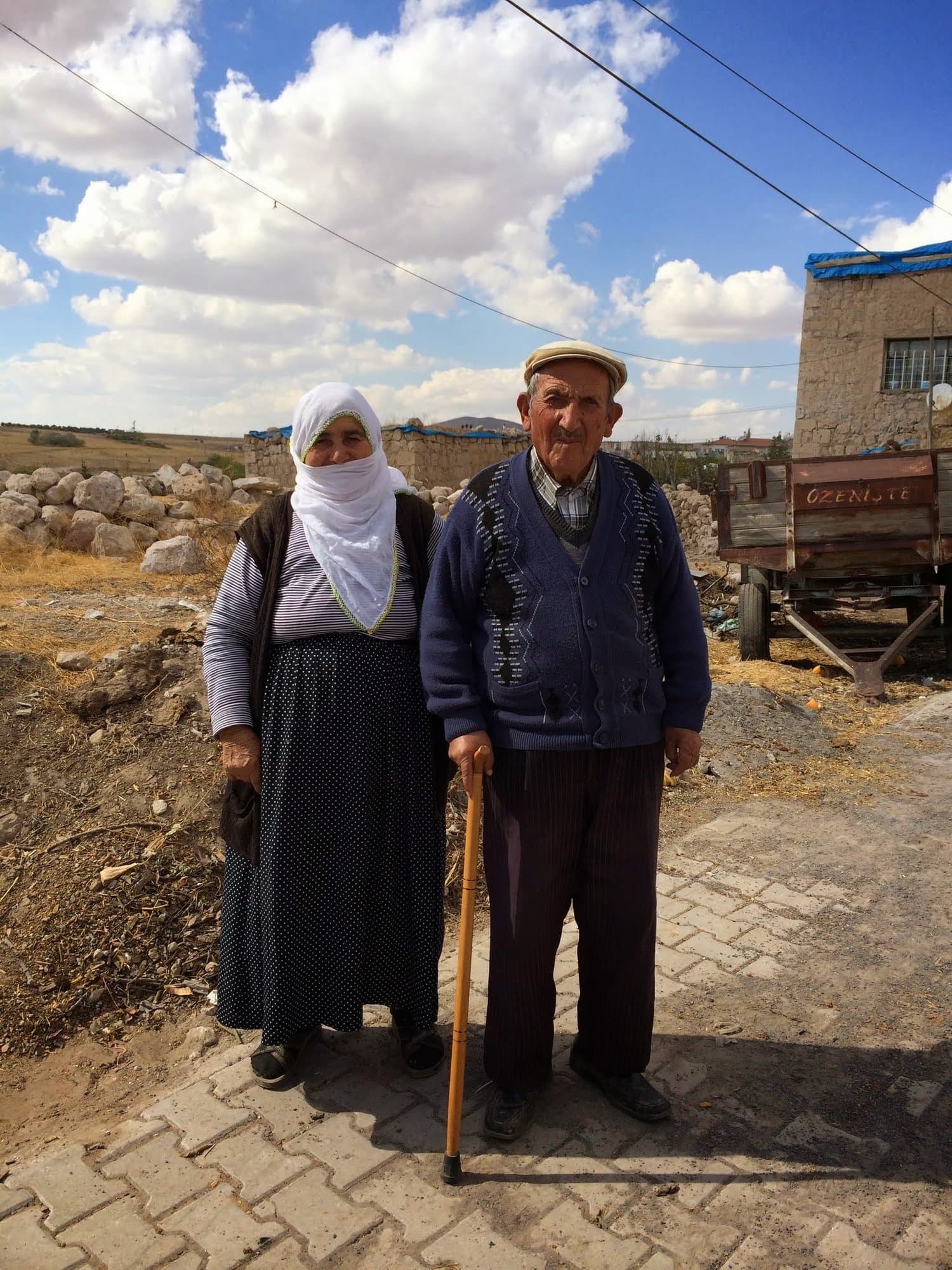 Elderly couple in traditional dress standing on a village street in Cappadocia