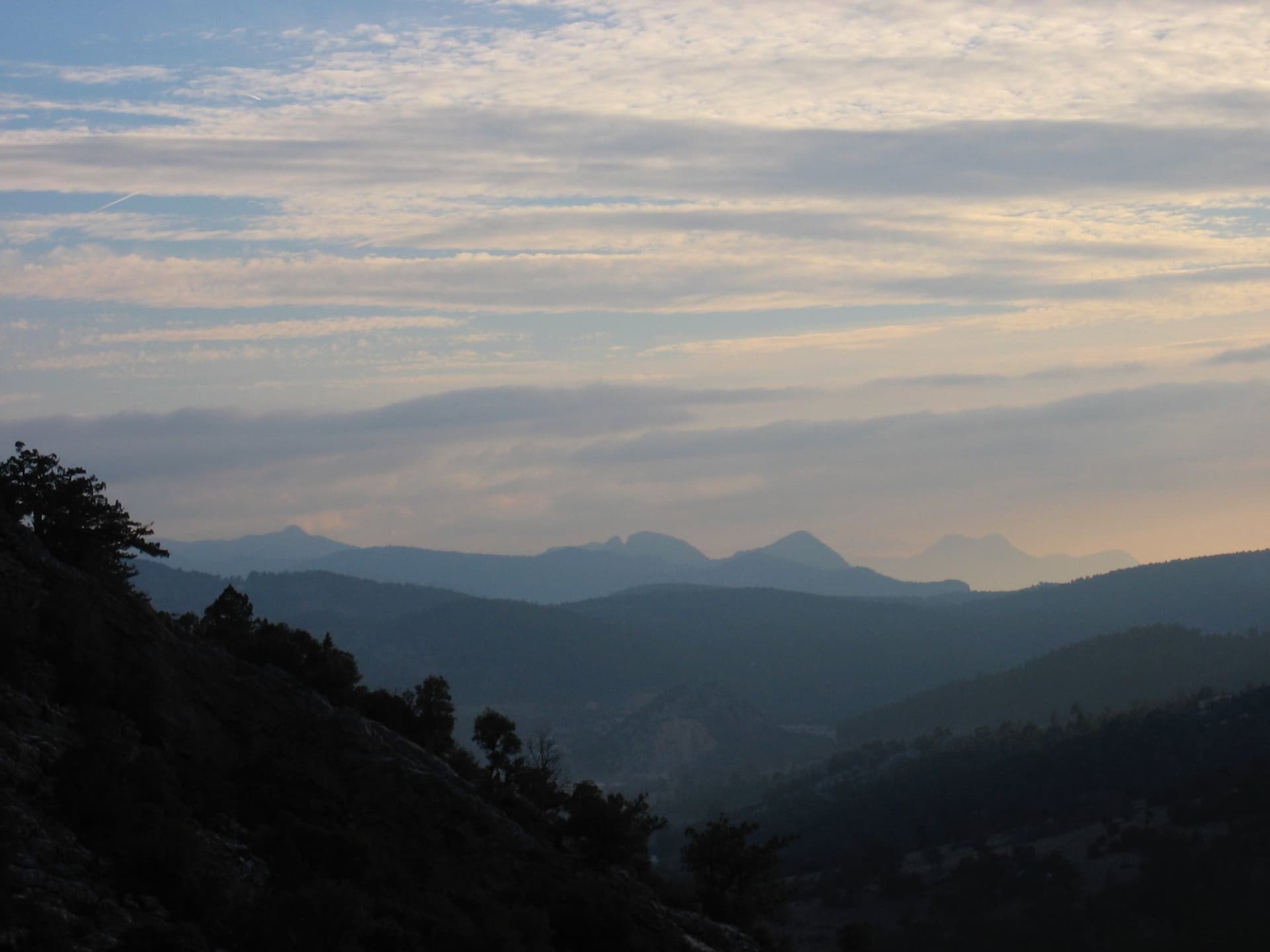 Layered mountain silhouettes beneath a hazy dusk sky in the Taurus Mountains