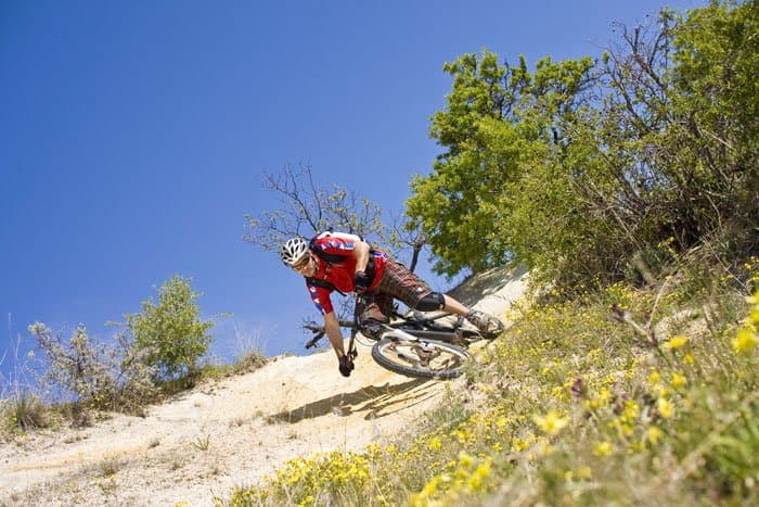 Mountain biker leaning into a turn on a dirt slope in Cappadocia