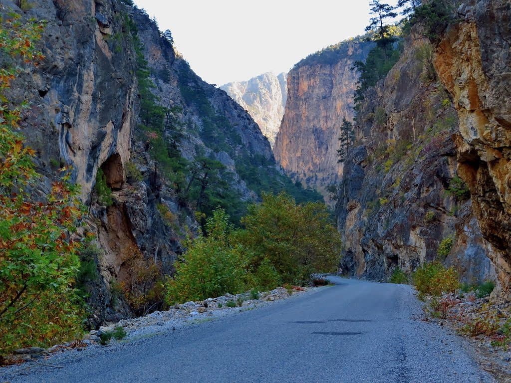 Paved road winding through a narrow rocky canyon in Cappadocia