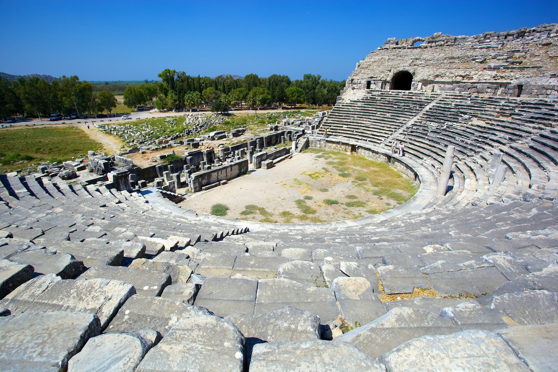 Tiered stone seating of an ancient amphitheater on the Aegean coast