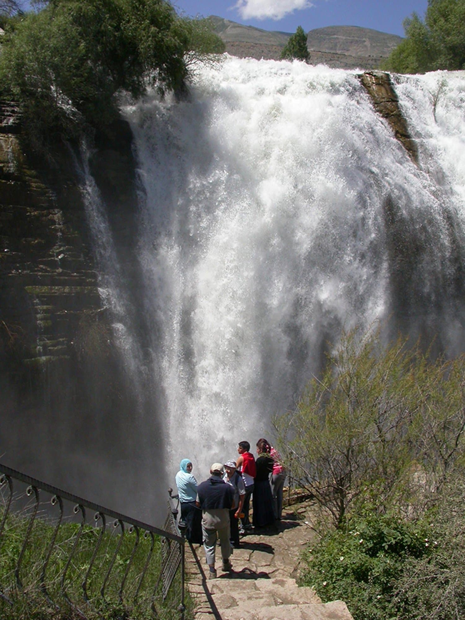 Visitors watching a powerful waterfall from a railed platform in the Kackar Mountains