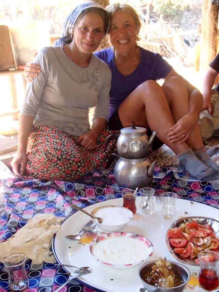 Two women sharing a traditional meal at a low table in the Taurus Mountains